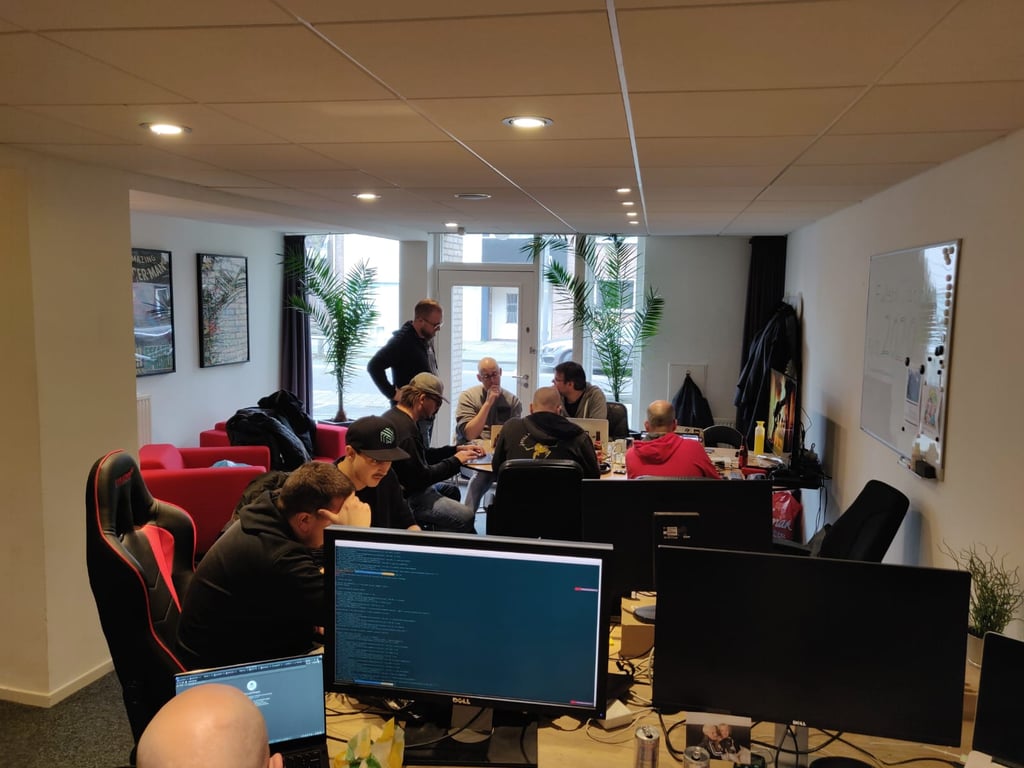 Hackathon team microservices: office room with a bunch of engineers collaborating